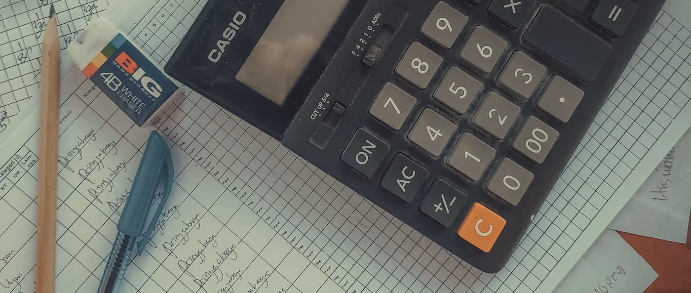 A calculator resting on an accounting ledger.