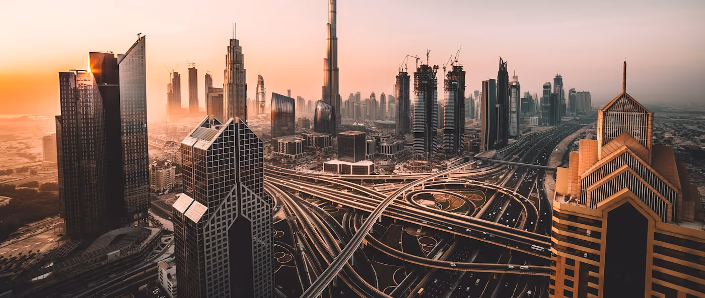 Aerial view of the Dubai skyline at sunrise.