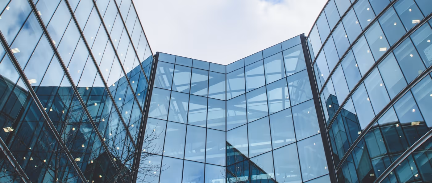 Modern glass office towers against the sky.