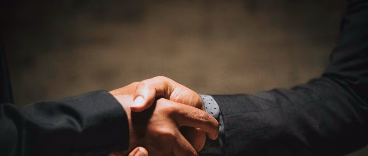 Two business people shaking hands.